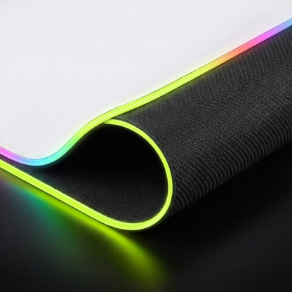 Side view of RGB mousepad edge showing thick black non‑slip rubber base, pure white top layer and glowing RGB border.