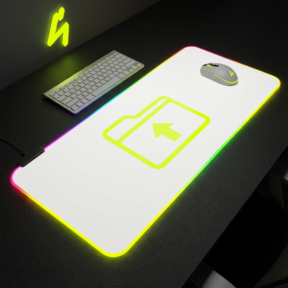 Glowing desk mat with keyboard and mouse on a dark surface